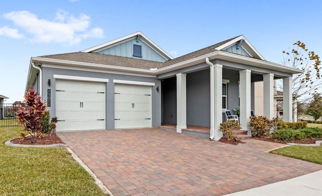 view of front of home featuring a porch and a garage