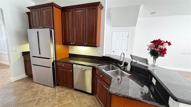 kitchen with refrigerator, crown molding, sink, stainless steel dishwasher, and kitchen peninsula