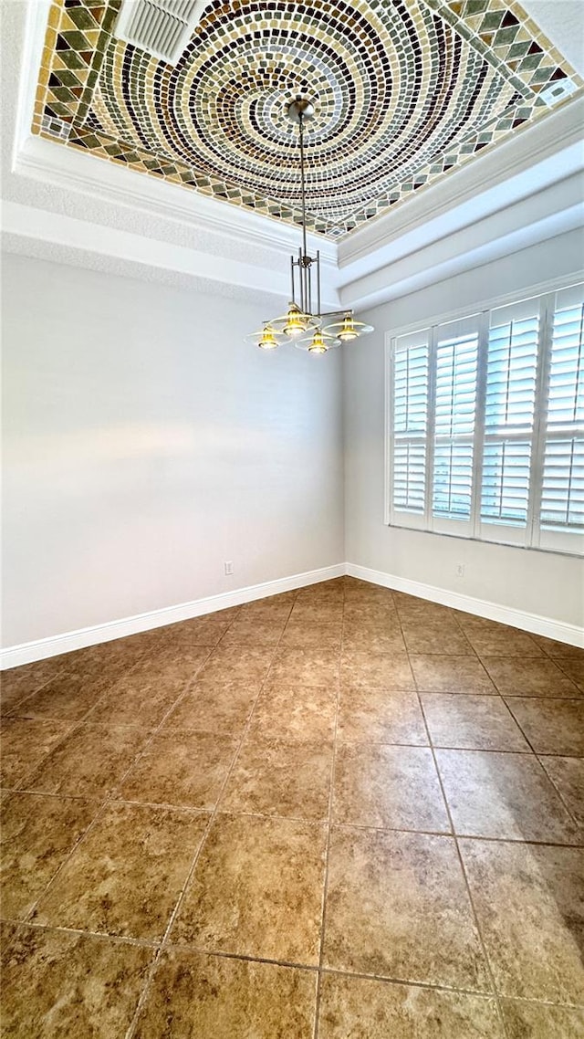 interior space featuring a towering ceiling, a tray ceiling, crown molding, and a notable chandelier