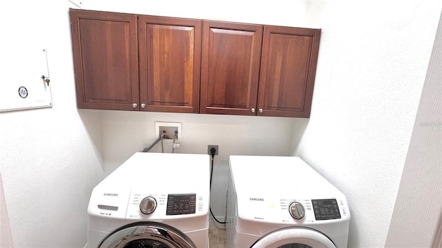 washroom with cabinets and independent washer and dryer