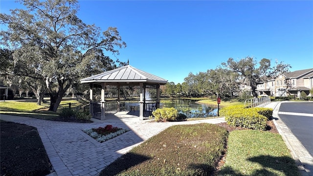 surrounding community with a gazebo and a water view