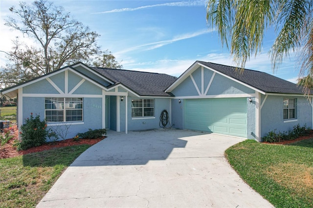 single story home with a garage and a front lawn