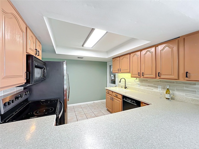 kitchen with sink, tasteful backsplash, a raised ceiling, and black appliances