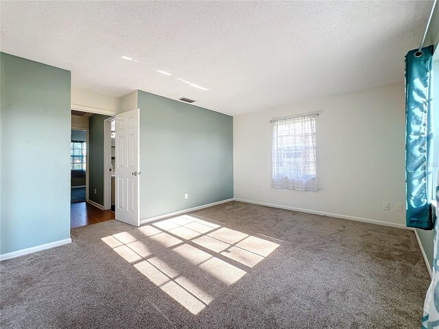 empty room featuring carpet floors and a textured ceiling