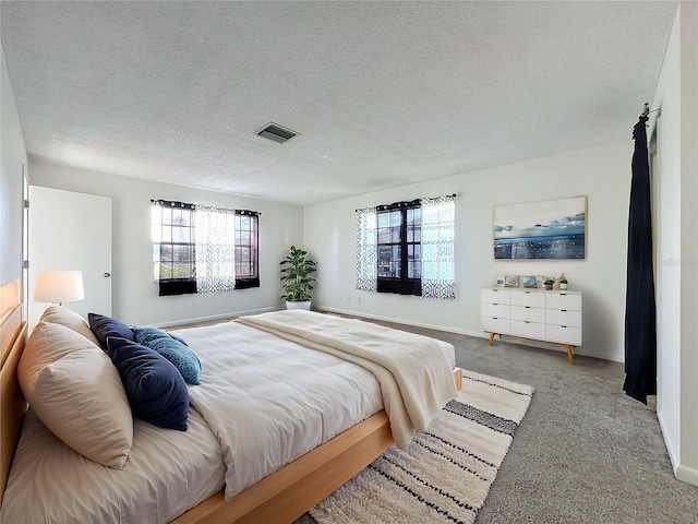 carpeted bedroom featuring a textured ceiling