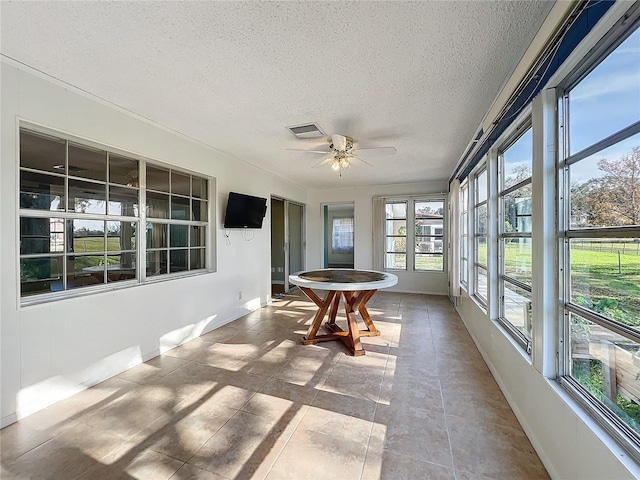 sunroom featuring ceiling fan