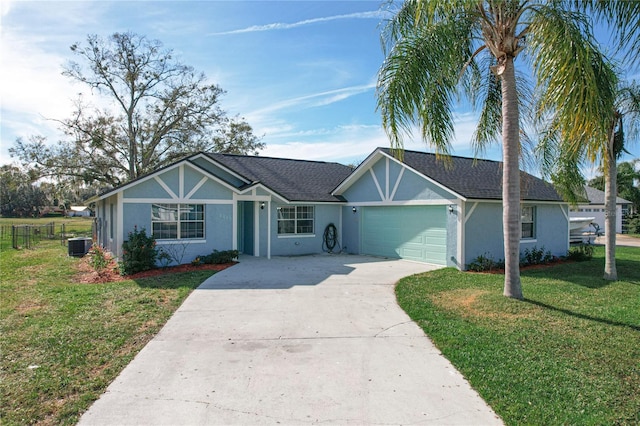 single story home with a garage, a front lawn, and cooling unit