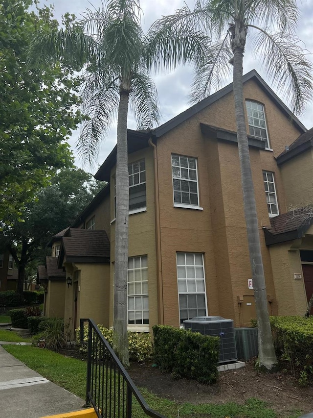 view of side of home featuring central AC unit