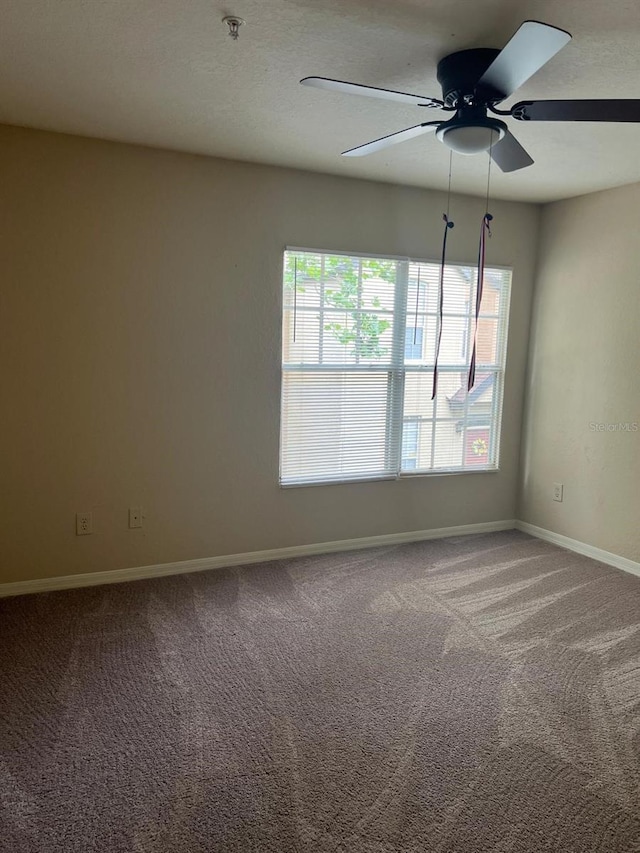 spare room featuring carpet flooring and ceiling fan