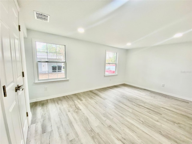 spare room featuring plenty of natural light and light wood-type flooring