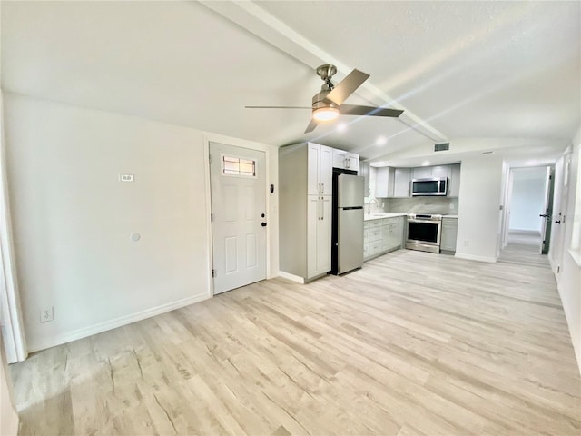 unfurnished living room with light wood-type flooring, lofted ceiling with beams, and ceiling fan