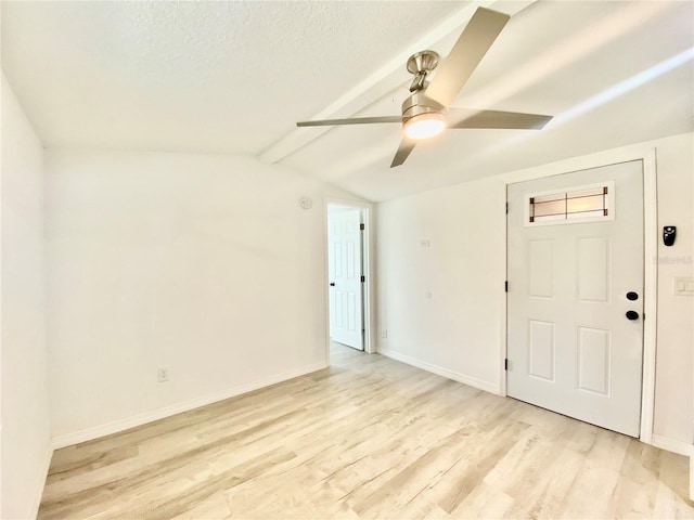 spare room with vaulted ceiling with beams, light hardwood / wood-style floors, a textured ceiling, and ceiling fan