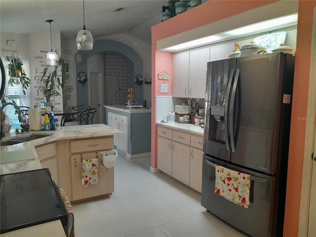 kitchen with stainless steel fridge with ice dispenser, backsplash, light tile patterned flooring, hanging light fixtures, and sink