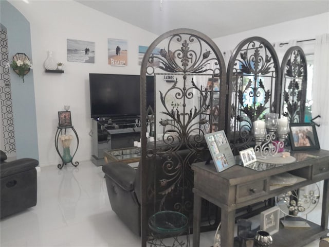 tiled living room with lofted ceiling