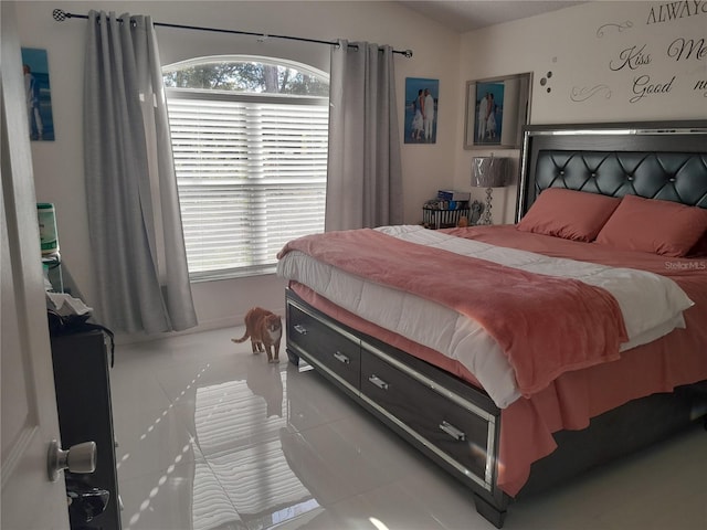 tiled bedroom with vaulted ceiling