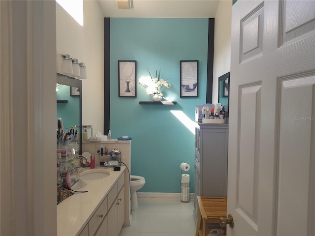 bathroom with vanity, tile patterned flooring, and toilet