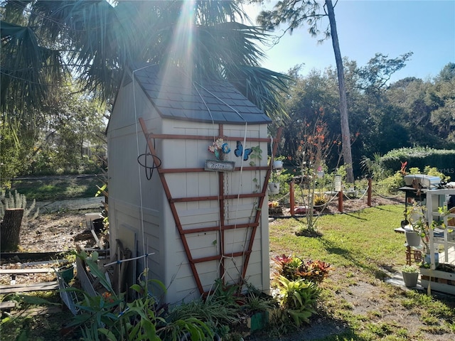 view of outbuilding with a yard