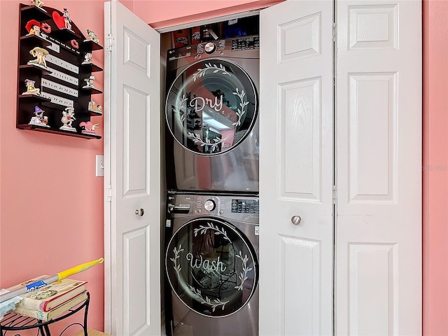 clothes washing area featuring stacked washer / drying machine