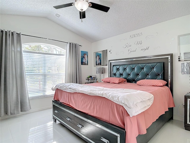 bedroom featuring ceiling fan, vaulted ceiling, a textured ceiling, and light tile patterned floors