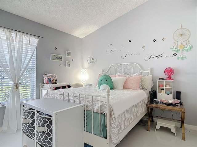 tiled bedroom featuring vaulted ceiling and a textured ceiling