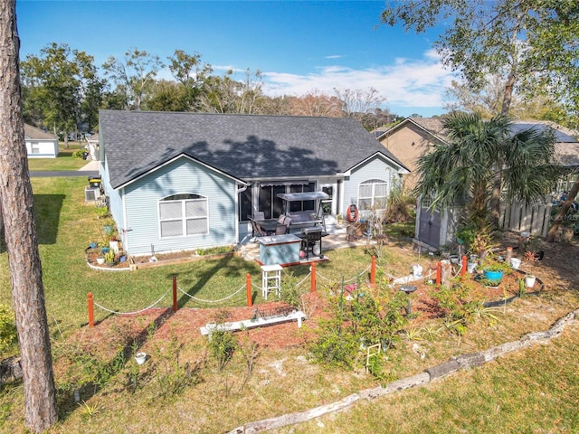 rear view of property featuring a yard