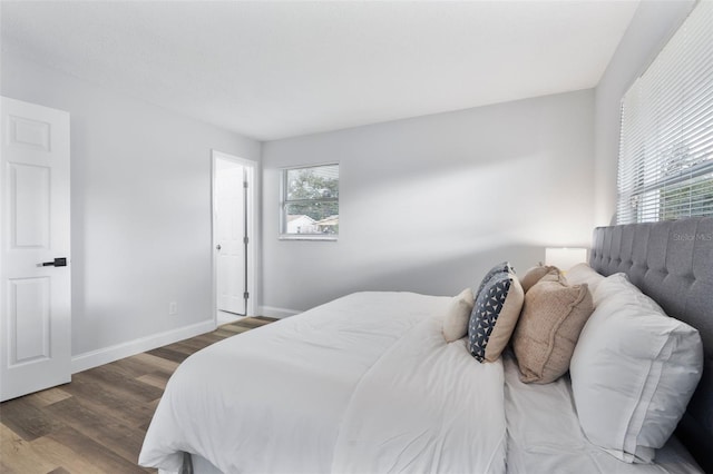 bedroom with dark wood-type flooring