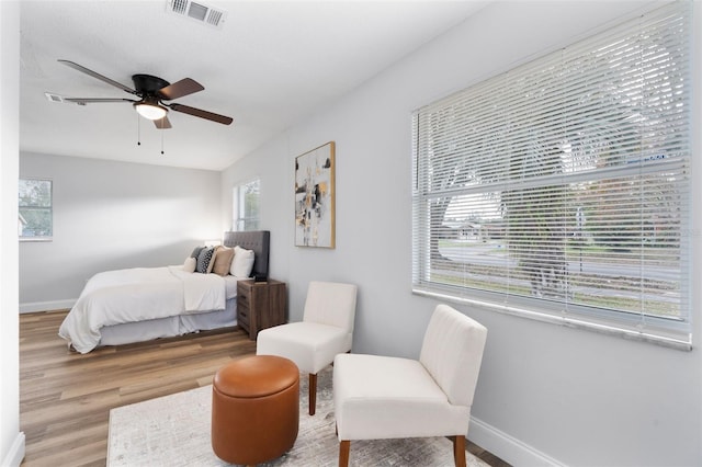 bedroom with ceiling fan and wood-type flooring