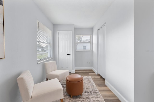 sitting room featuring a wealth of natural light and hardwood / wood-style flooring