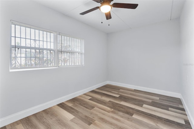 unfurnished room with ceiling fan and hardwood / wood-style flooring