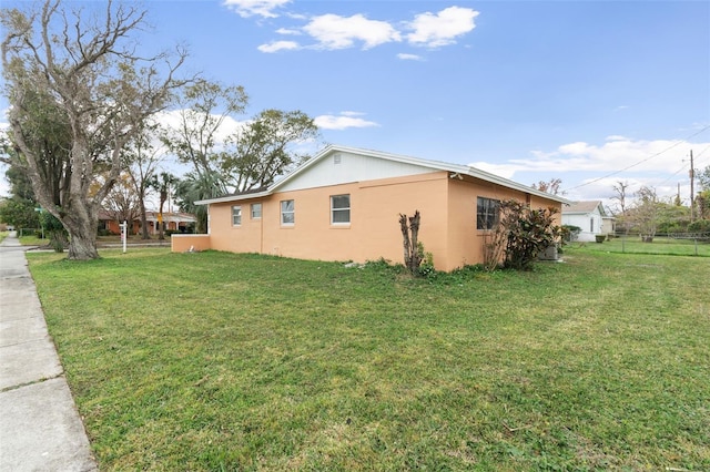 view of side of home featuring a lawn