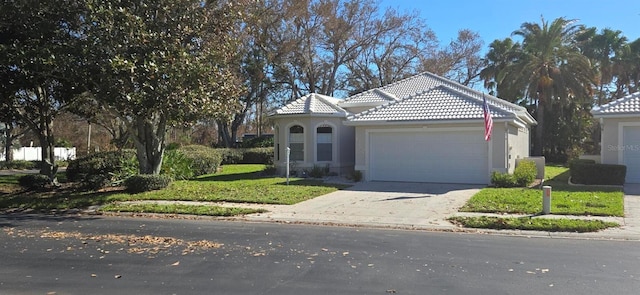 mediterranean / spanish-style house featuring a front lawn and a garage