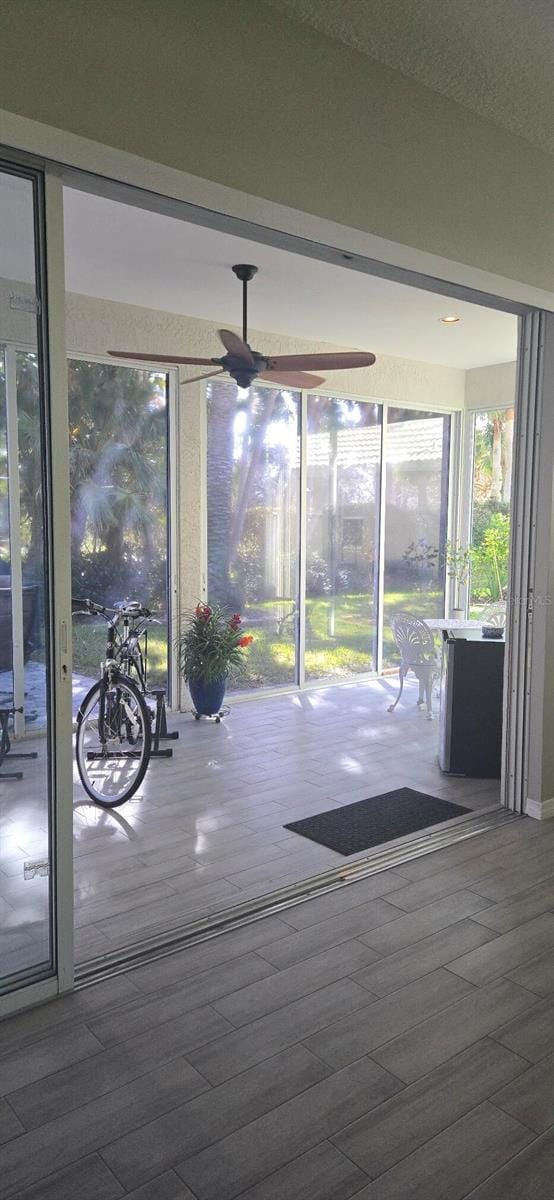 entryway with hardwood / wood-style flooring and ceiling fan