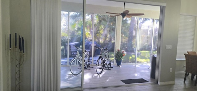 doorway featuring ceiling fan