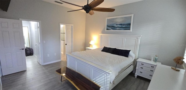 bedroom featuring ceiling fan, dark hardwood / wood-style flooring, and vaulted ceiling