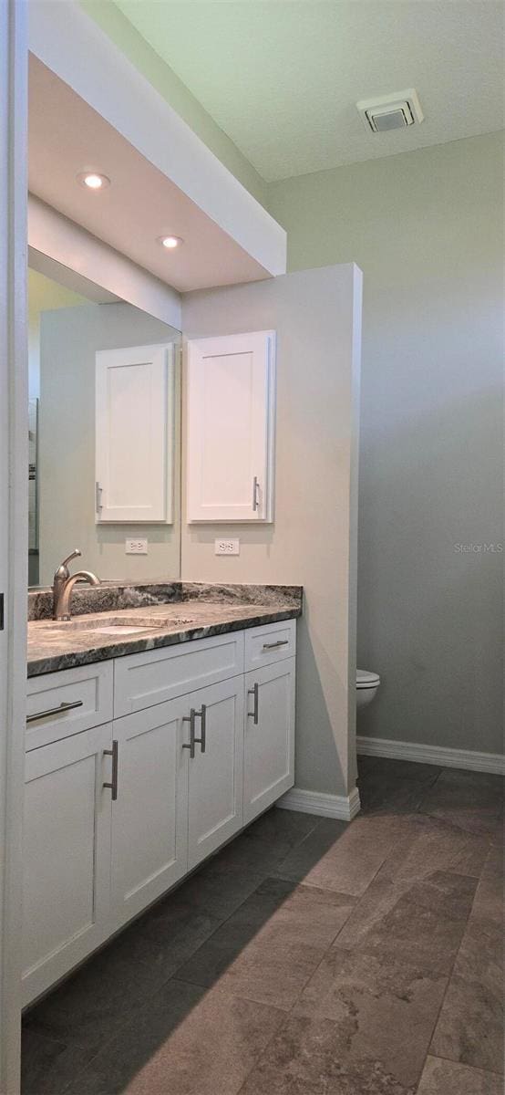 bathroom with vanity and toilet