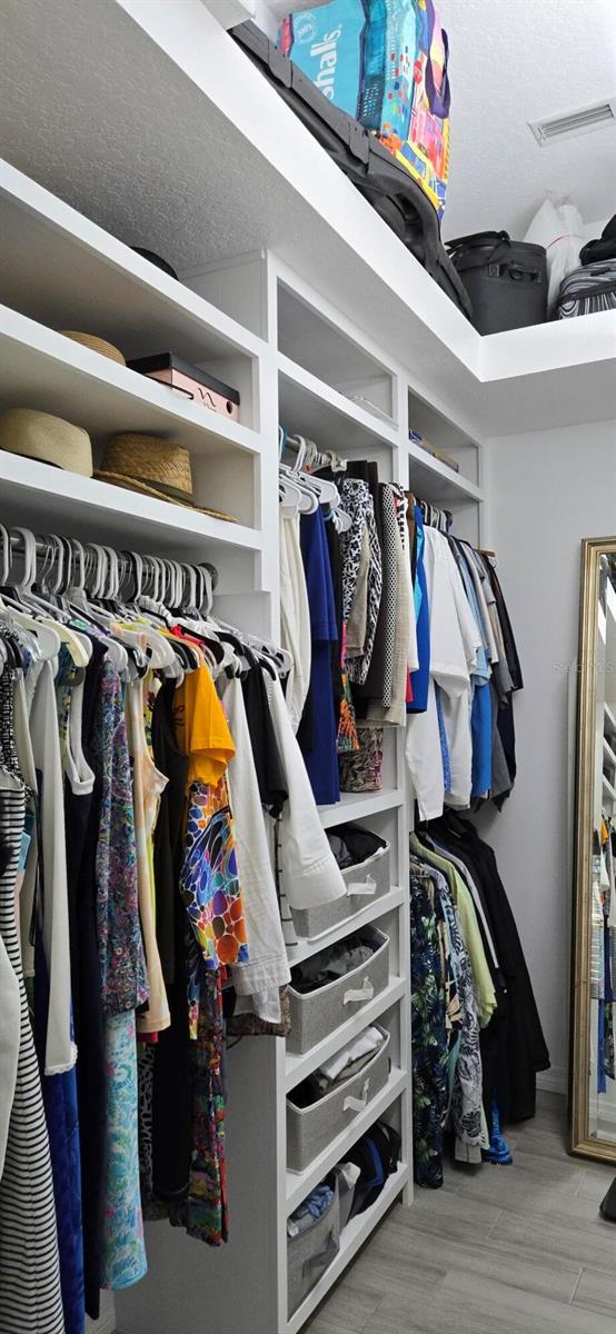 spacious closet with hardwood / wood-style flooring