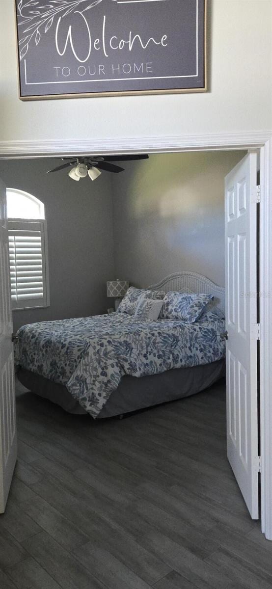 bedroom featuring dark wood-type flooring and ceiling fan