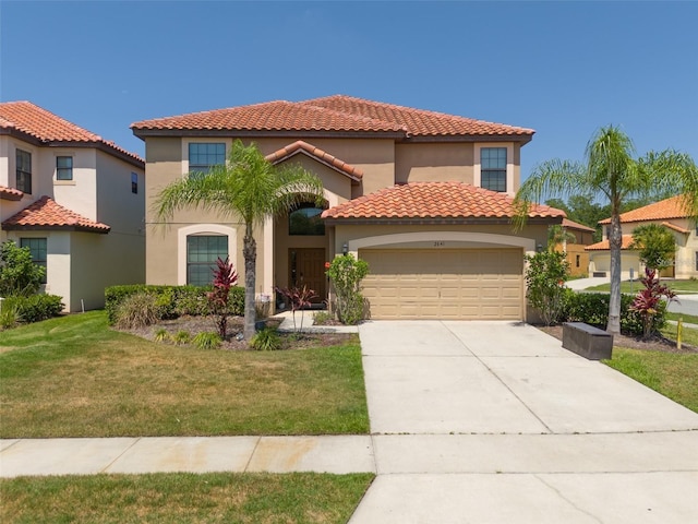 mediterranean / spanish-style house with a garage and a front yard