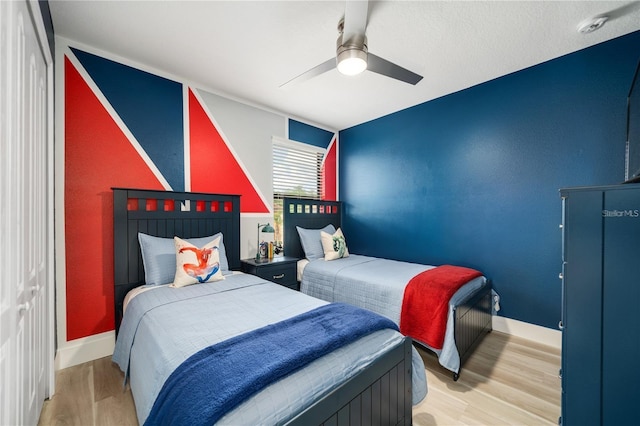 bedroom with light hardwood / wood-style flooring and ceiling fan