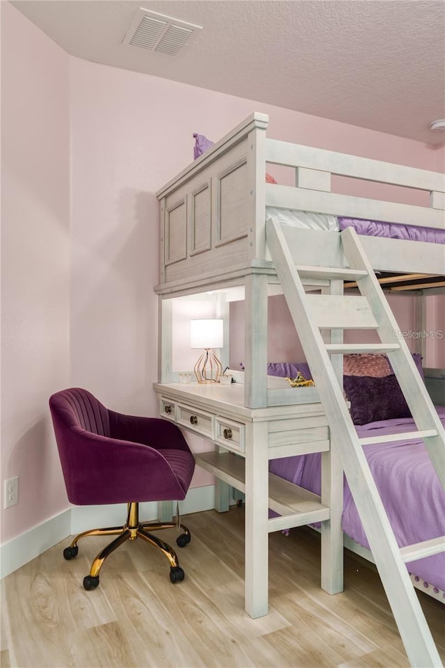 bedroom with light wood-type flooring