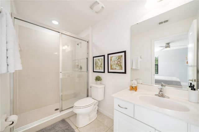 bathroom featuring vanity, tile patterned floors, ceiling fan, toilet, and a shower with shower door