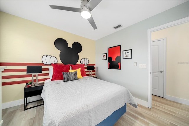 bedroom with ceiling fan and light hardwood / wood-style floors