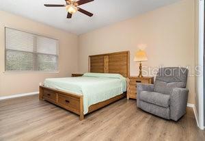 bedroom with ceiling fan and light wood-type flooring