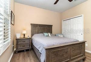 bedroom with hardwood / wood-style flooring, ceiling fan, and a closet