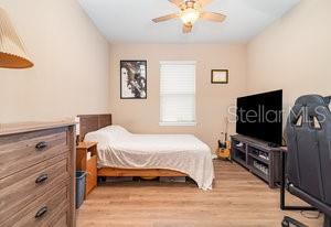 bedroom with ceiling fan and light hardwood / wood-style floors