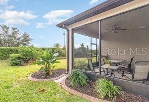 view of yard with a sunroom and ceiling fan