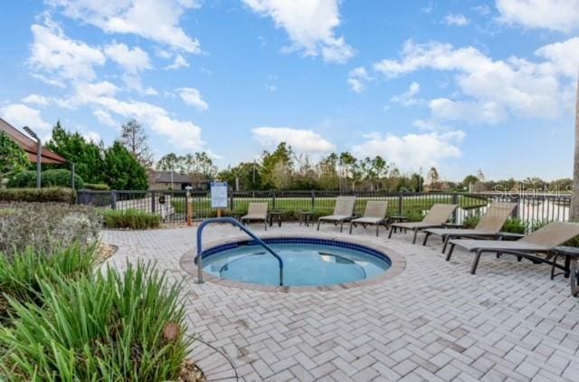 view of swimming pool with a hot tub