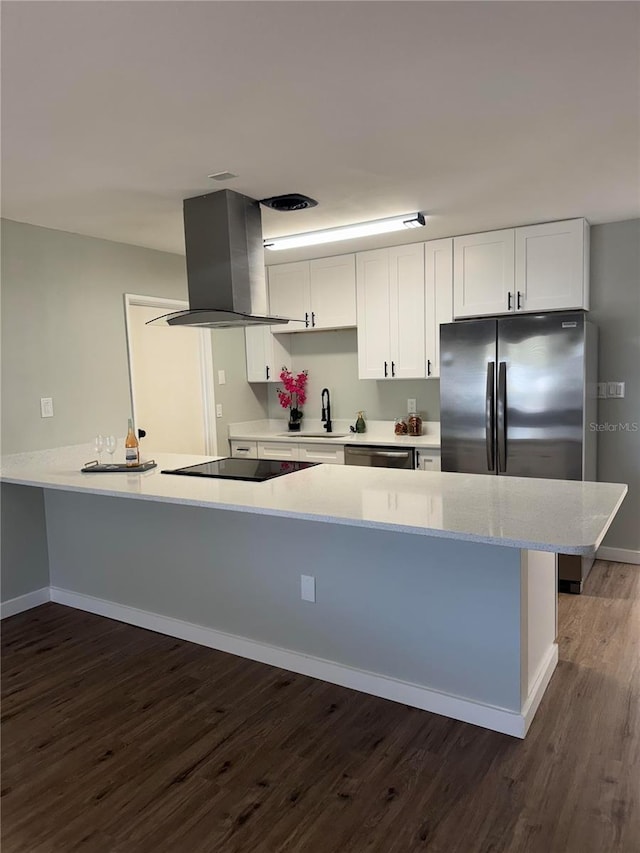 kitchen with island range hood, white cabinetry, stainless steel appliances, and dark wood-type flooring