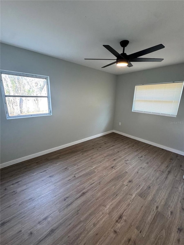 unfurnished room with dark hardwood / wood-style floors and ceiling fan