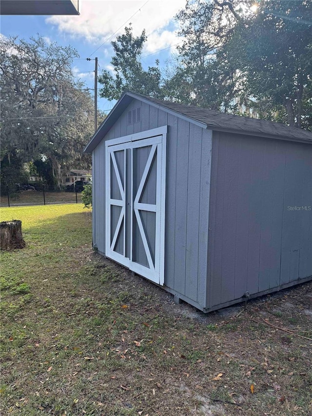 view of outbuilding featuring a yard